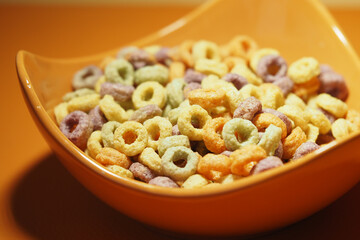 Colorful cereal in a bowl on a bright surface