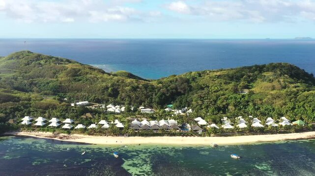 Sandy beach at Tokoriki island resort with coral reef in Fiji on Pacific island &ndash; aerial 4k.
