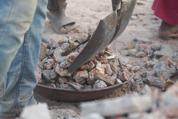 Workers removing rubble from a construction site