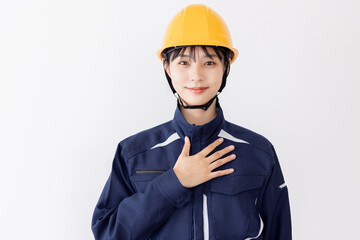 作業服の女性　胸に手を当てる　自信・信頼
