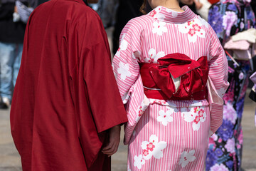 Young girl wearing Japanese kimono standing in front of Sensoji Temple in Tokyo, Japan. Kimono is a Japanese traditional garment. The word "kimono", which actually means a "thing to wear"