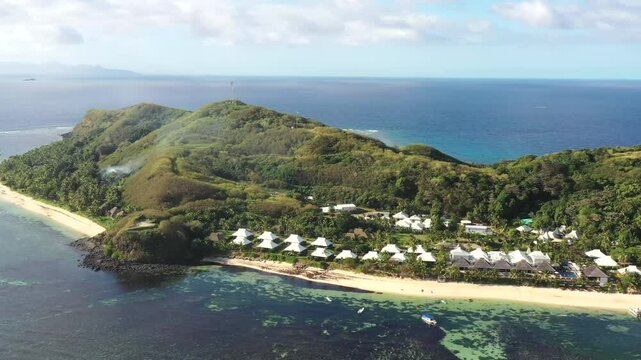 High aerial panorama of Tokoriki island in Fiji Mamanuca islands on Pacific ocean reefs.
