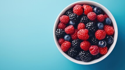 Fresh Assortment of Colorful Berries Including Raspberries, Blackberries, and Blueberries in a White Bowl