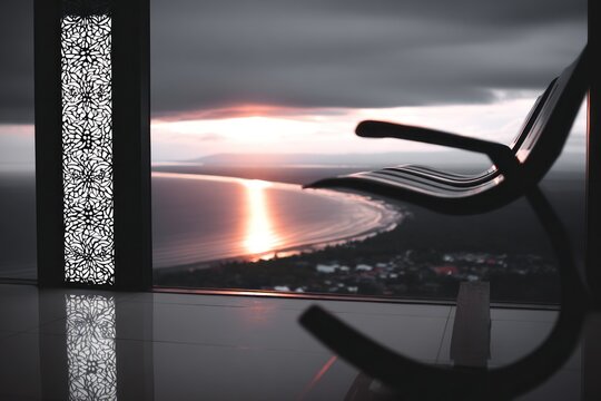 Panoramic view of a sunset over the ocean from a high vantage point, with a simple bench in the foreground