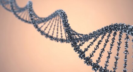 A close up view of a metallic dna strand against a light orange background in a studio setting