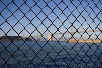 Fototapeta premium chain fence with bridge in background