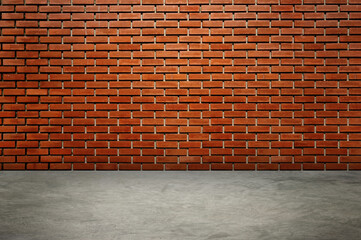 An empty room with red brick walls. The red brick walls are lit with warm lighting.