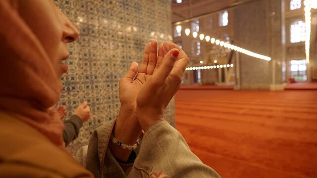 Woman praying inside a mosque with beautiful decor