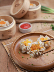 Dumplings on wooden plate and wooden table