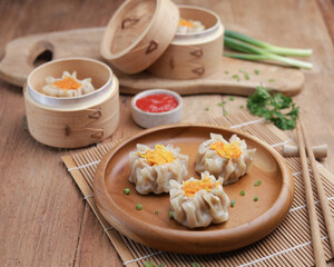 Dumplings on wooden plate and wooden table
