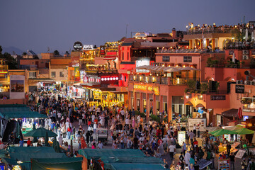Elevated night street view of market stalls and restaurants at Jemaa el-Fnaa in the Old Town Medina area of Marrakech, west Morocco 
