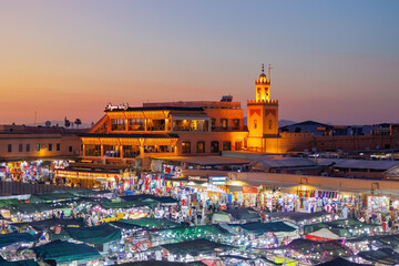Elevated night street view of market stalls and restaurants at Jemaa el-Fnaa in the Old Town Medina area of Marrakech, west Morocco 