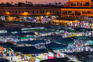 Elevated night street view of market stalls and restaurants at Jemaa el-Fnaa in the Old Town Medina area of Marrakech, west Morocco 