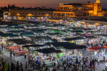 Elevated night street view of market stalls and restaurants at Jemaa el-Fnaa in the Old Town Medina area of Marrakech, west Morocco 