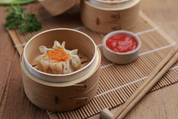 Dumplings on wooden plate and wooden table