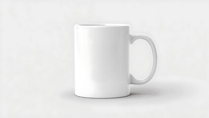 Obraz premium A simple white ceramic mug with a handle isolated on a plain white background in a studio shot
