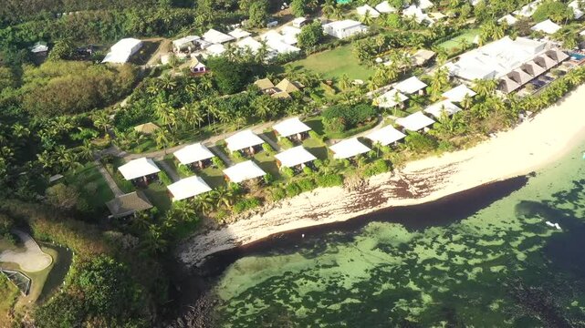 Cotteges at Tokoriki island resort in tropical Fiji coral reefs &ndash; aerial flying over as 4k.
