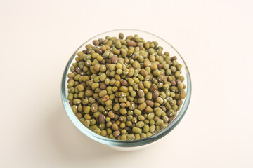 Mung beans in transparent bowl on white background