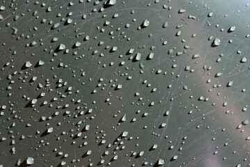 Water drops and scratches on a dark grey gray surface textured background