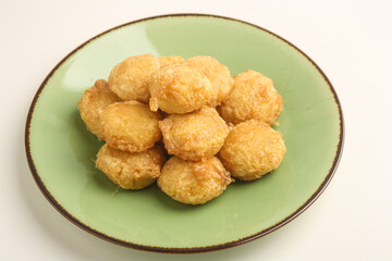 Potato fritter on green plate on white background