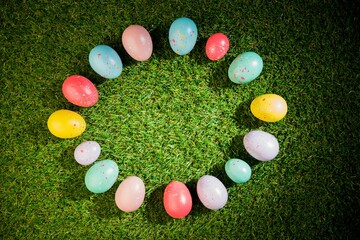 Colorful Easter eggs in circle on grass
