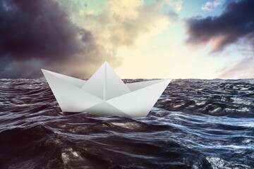 Paper boat floating on the sea