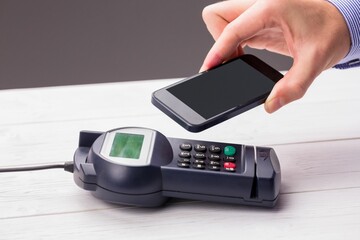 Man using smartphone to express pay