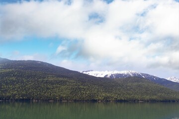 Mountains by river against sky