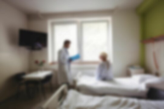 Doctor talking to patient in hospital room