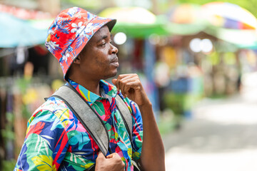 A cheerful tourist in a vibrant shirt walks through a Thai street market, enjoying the atmosphere and connecting with local culture