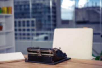 Defocused image of vintage typewriter on table