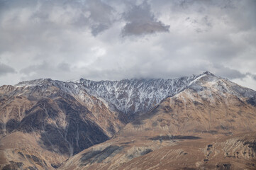 Majestic snow-covered Himalayan peak seen from Diskit Monastery in Nubra Valley, Ladakh — serene...