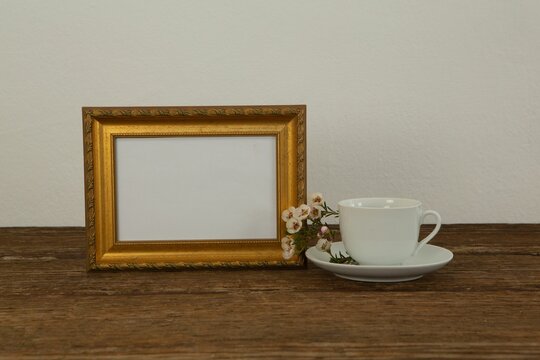 Fototapeta Photo frame and coffee cup on table