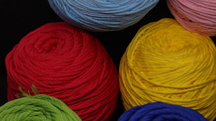 Colorful threads for crochet on black background