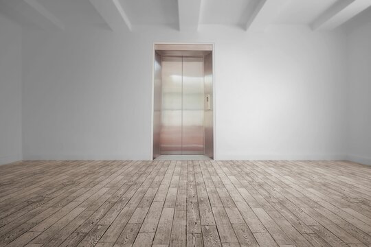 Fototapeta Empty lobby is featuring wood flooring and exposed ceiling beams with stainless steel elevator door