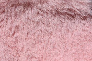 Light pink plush faux fur fabric close-up abstract background texture