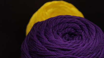 Colorful threads for crochet on black background