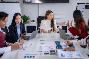 Business team discussing financial charts and data analysis during meeting
