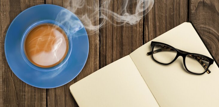 Fototapeta Overhead view of hot tea by hand writing on book