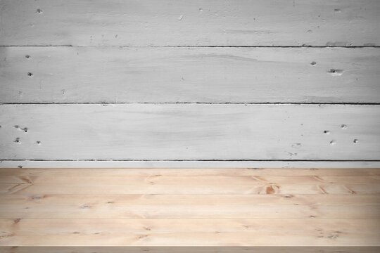 Fototapeta Light brown wooden tabletop is being shown in flat design, with whitewashed plank wall backdrop