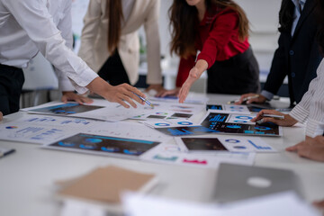 Business people analyzing charts and graphs, discussing financial strategy in a meeting