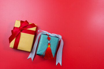 minimal flat lay chinese new year decoration item and gift box on red background