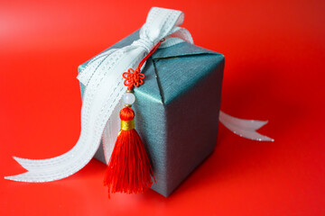 minimal flat lay chinese new year decoration item and gift box on red background