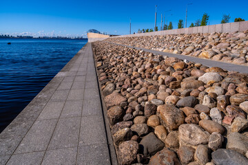 The embankment along the river is fortified with stones.