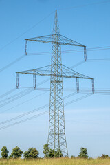 An electricity pylon with power lines seen in Germany