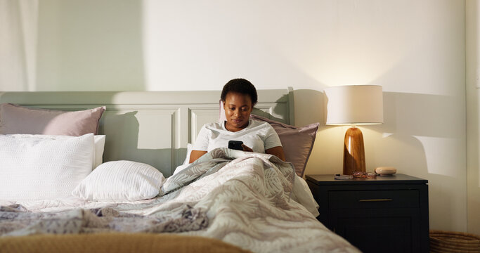 Reading, phone and wake up with black woman in bedroom for chat, notification and morning routine. Relax, social media and wellness with person in home for contact, typing and online news update