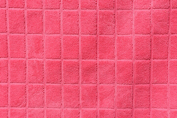 Pink fabric with a grid pattern close-up abstract textured background