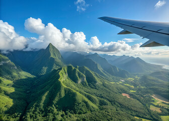 Aerial View of Island Mountains: An airplane wing provides a unique perspective on a breathtaking vista of lush, verdant mountains rising from a tropical island.