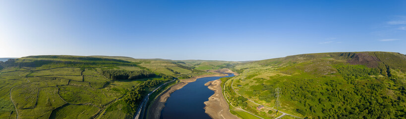Obraz premium Aerial view of a dramatically low Woodhead Reservoir during drought conditions, The reservoir, part of a system supplying drinking water to Greater Manchester, lies in North Derbyshire, June 2025