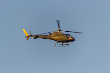 Helicopter Flies Across a Clear Sky